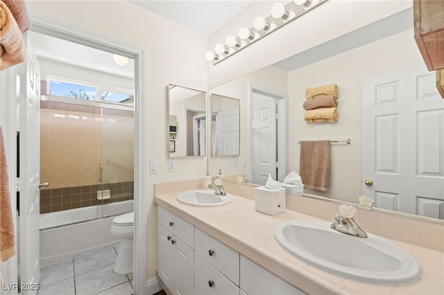 full bathroom featuring tile patterned flooring, vanity, toilet, and shower / bath combination with glass door