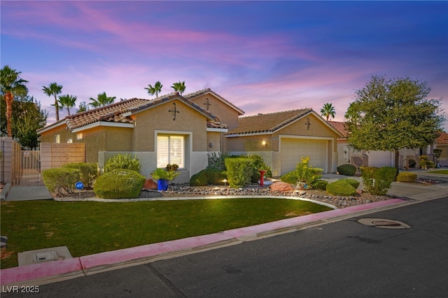 view of front of property with a lawn and a garage