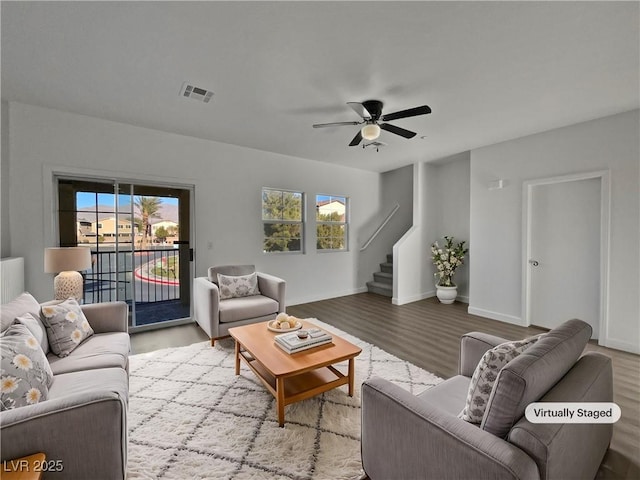 living room featuring wood-type flooring and ceiling fan