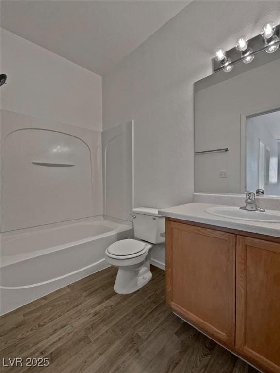 full bathroom featuring shower / washtub combination, hardwood / wood-style floors, vanity, and toilet