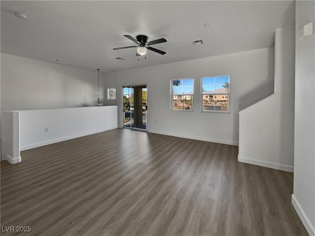 unfurnished living room with ceiling fan and dark hardwood / wood-style flooring