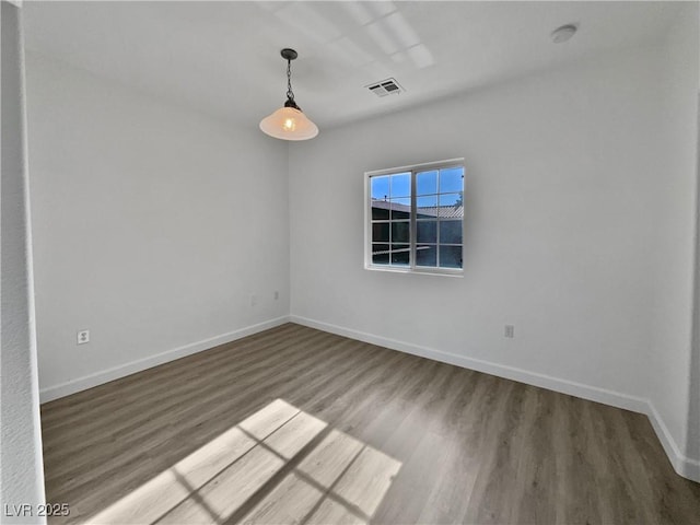 unfurnished room with hardwood / wood-style floors