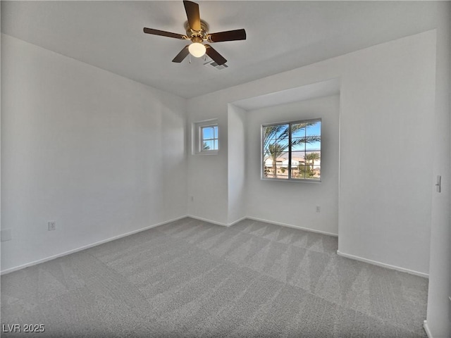 carpeted spare room with ceiling fan