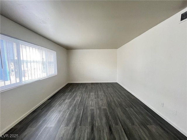 empty room with dark hardwood / wood-style flooring