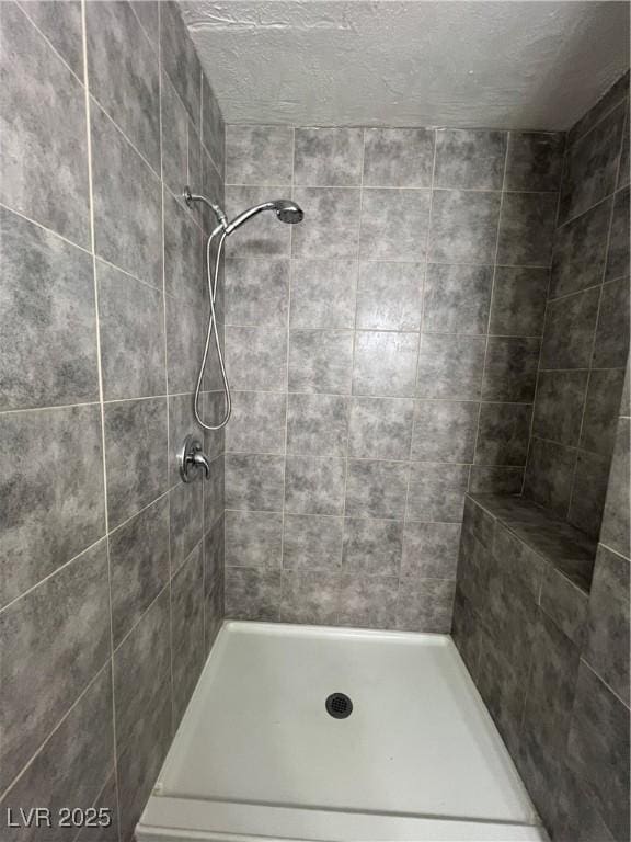 bathroom with tiled shower