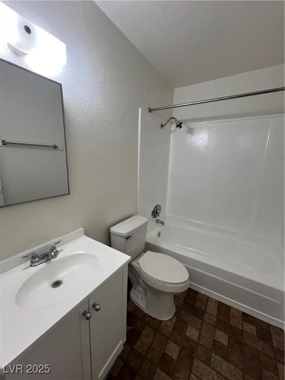 full bathroom with washtub / shower combination, vanity, and toilet