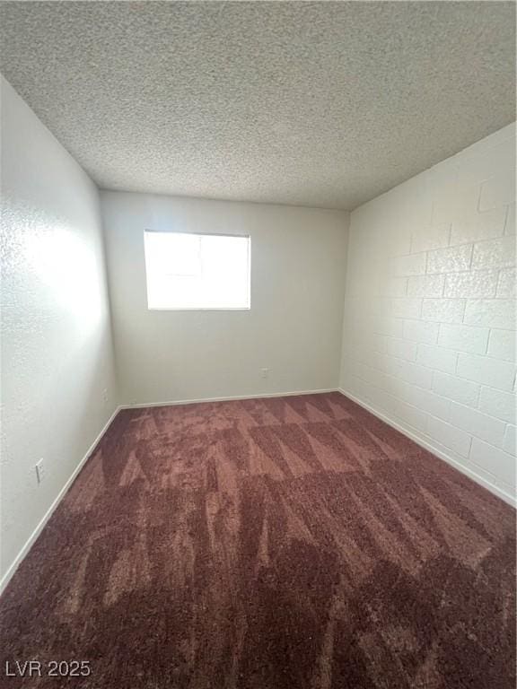 carpeted spare room with a textured ceiling