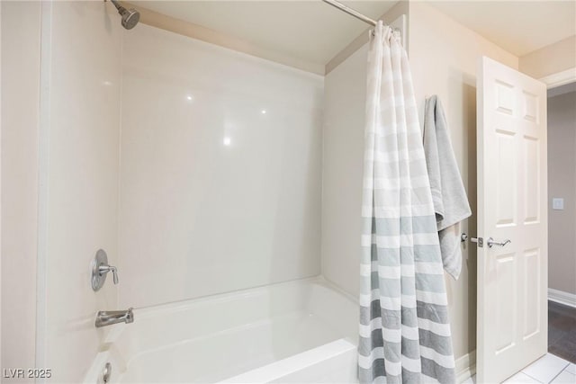 bathroom featuring tile patterned floors and shower / bath combo with shower curtain