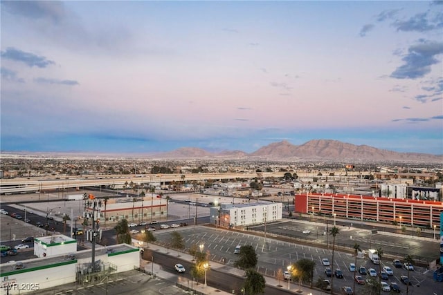 aerial view at dusk featuring a mountain view