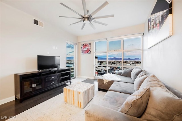 living room with wood-type flooring and ceiling fan