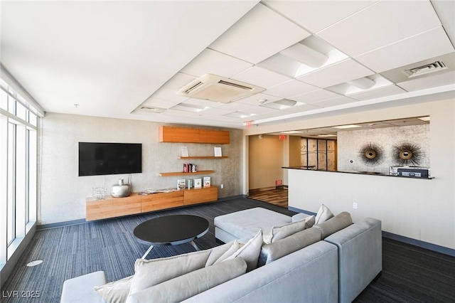 living room with a paneled ceiling