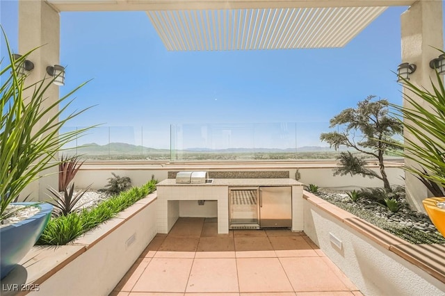 view of patio featuring area for grilling and a mountain view