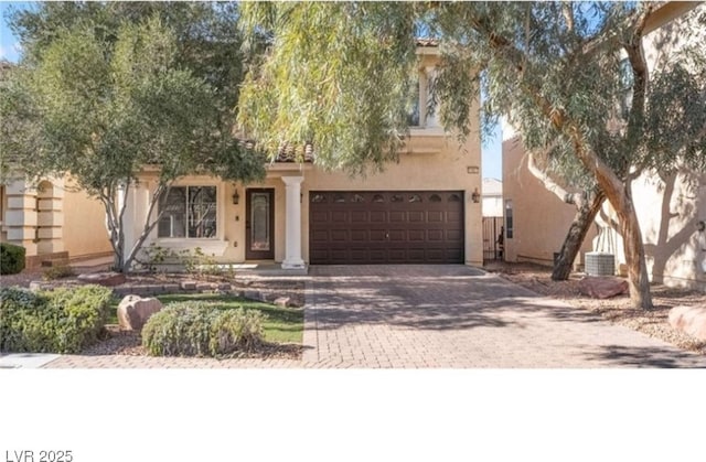 view of front of home with a garage and cooling unit