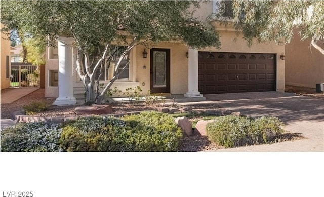 view of front of house with cooling unit and a garage