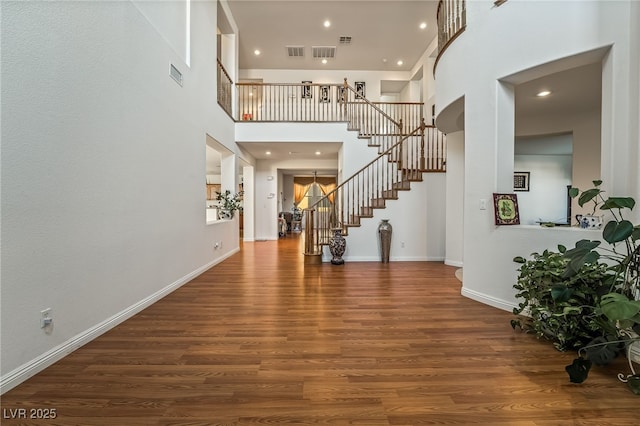 entrance foyer featuring dark hardwood / wood-style flooring and a high ceiling