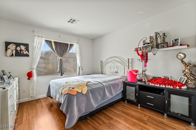 bedroom with hardwood / wood-style floors