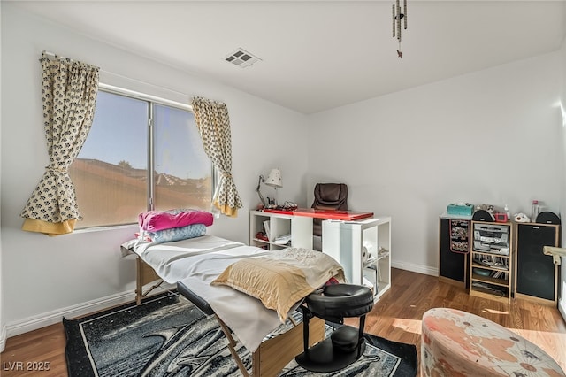 bedroom with hardwood / wood-style flooring