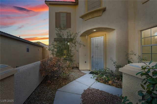 view of exterior entry at dusk