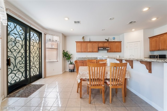 dining area with light tile patterned floors