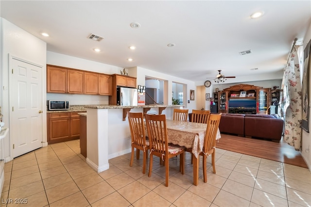 dining room with ceiling fan and light tile patterned flooring