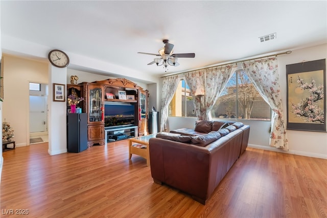 living room with ceiling fan and light wood-type flooring