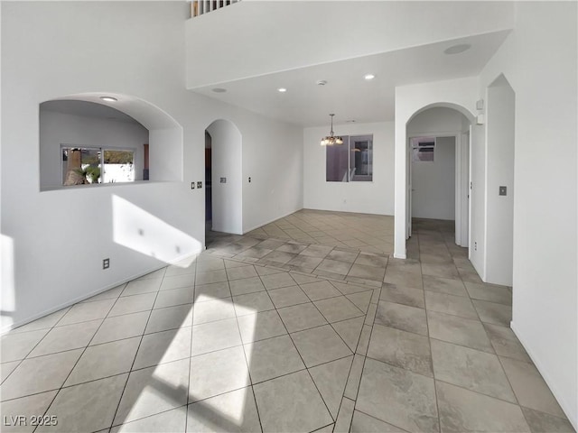 unfurnished room with an inviting chandelier