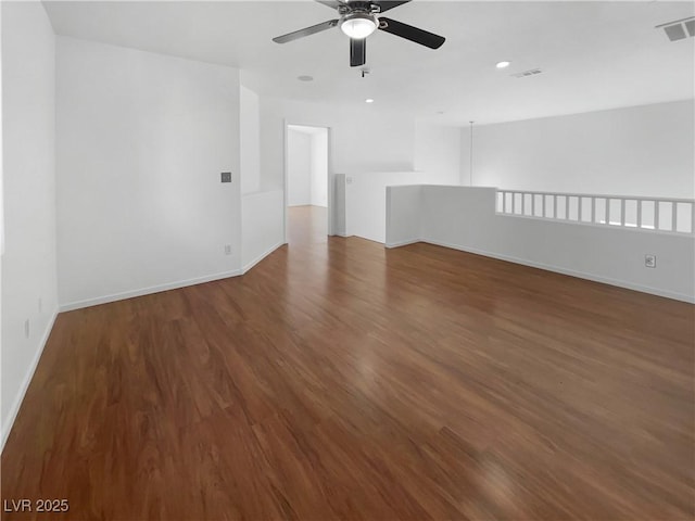 empty room featuring ceiling fan and dark wood-type flooring