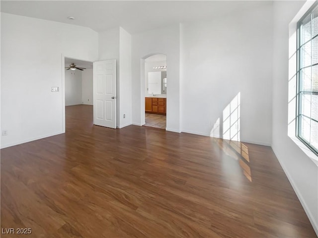 spare room with dark hardwood / wood-style flooring and ceiling fan