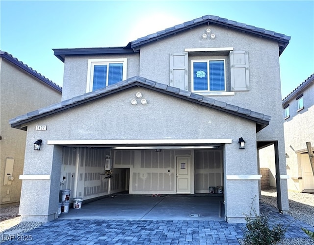 rear view of property with a garage