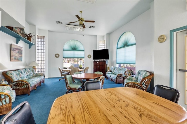 carpeted dining room featuring ceiling fan