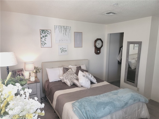 carpeted bedroom with a textured ceiling