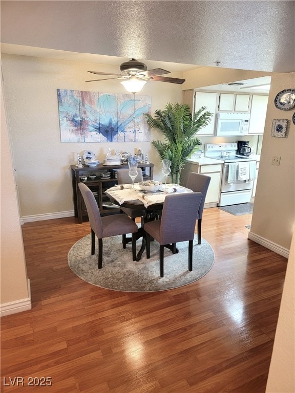 dining space featuring ceiling fan, light hardwood / wood-style flooring, and a textured ceiling