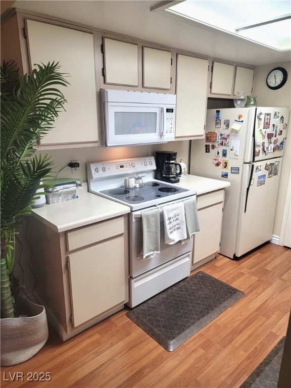 kitchen featuring white cabinetry, white appliances, and light hardwood / wood-style flooring