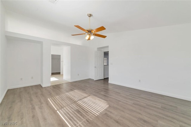 unfurnished room with vaulted ceiling, ceiling fan, and light hardwood / wood-style floors