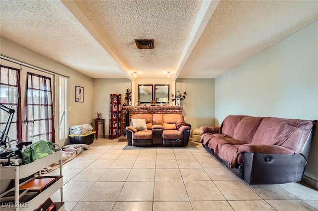 living area featuring light tile patterned floors and a textured ceiling