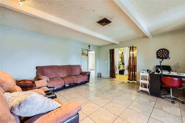 living area with beam ceiling, light tile patterned flooring, visible vents, and a textured ceiling