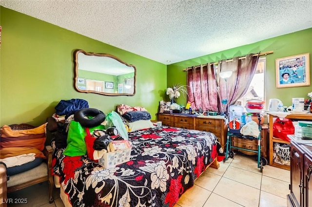 bedroom featuring tile patterned floors and a textured ceiling