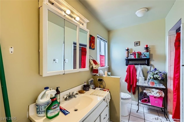 bathroom with vanity, tile patterned floors, and toilet