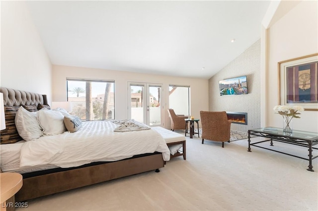 carpeted bedroom with access to outside and lofted ceiling