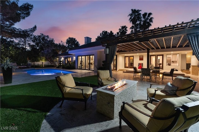 exterior space featuring a fire pit and a pergola