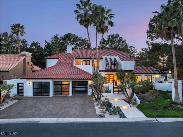 mediterranean / spanish house featuring a garage