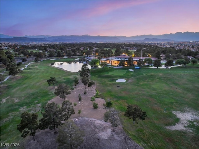 aerial view at dusk featuring a water and mountain view