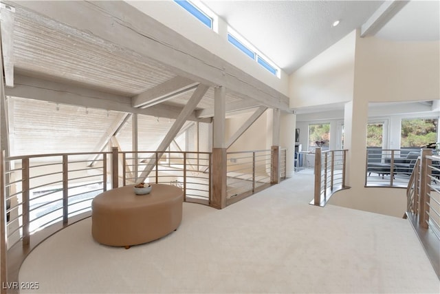 corridor featuring vaulted ceiling with beams and carpet floors