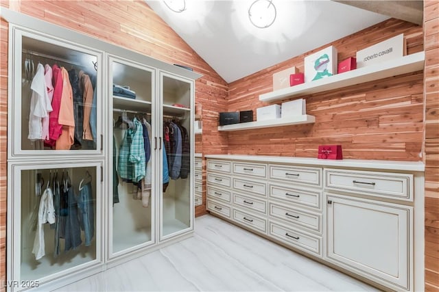 walk in closet with lofted ceiling