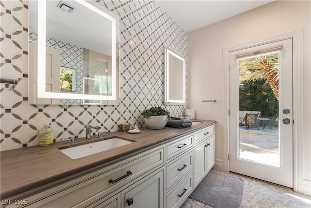 bathroom featuring decorative backsplash and vanity