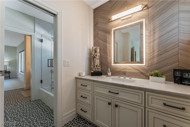 bathroom featuring vanity, a skylight, and a shower with door