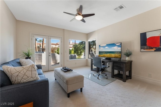 carpeted living room featuring ceiling fan and french doors