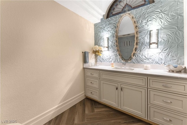 bathroom with vanity and parquet floors