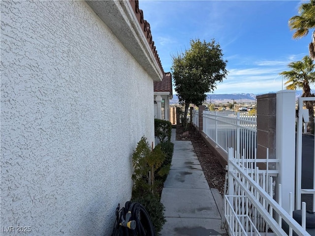 view of side of home with a mountain view