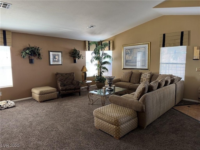 living room with carpet flooring, a healthy amount of sunlight, and vaulted ceiling